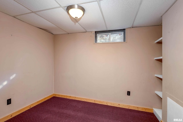 basement with a paneled ceiling