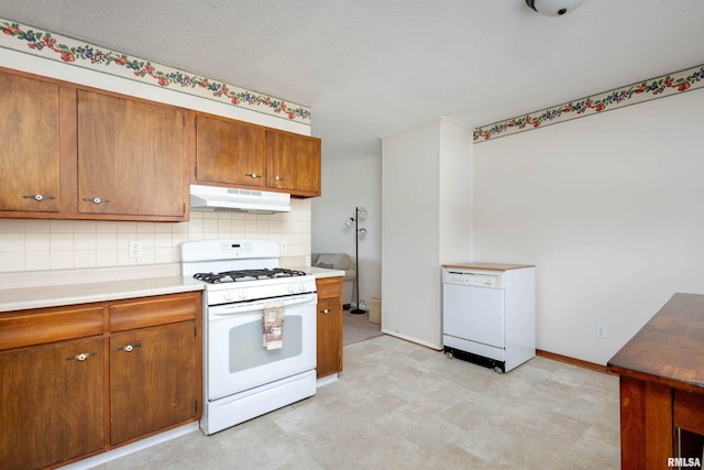 kitchen with white appliances and decorative backsplash