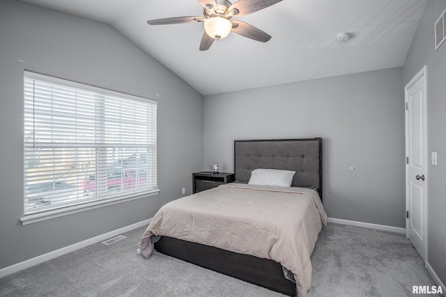 bedroom with ceiling fan, light colored carpet, and lofted ceiling