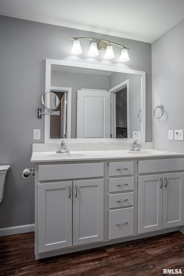 bathroom featuring toilet, wood-type flooring, and vanity