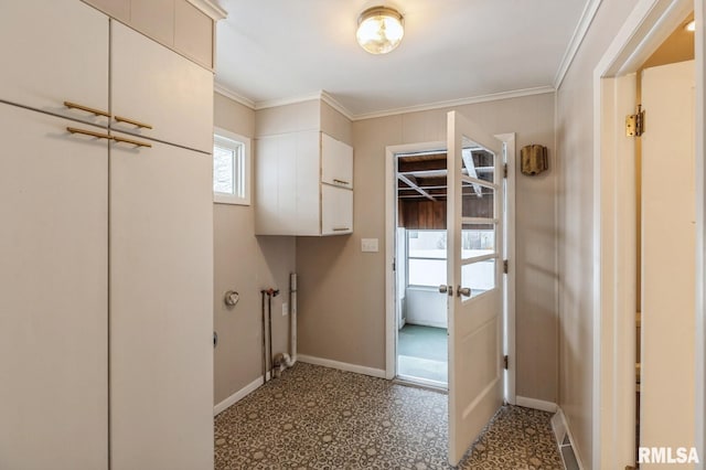 laundry area featuring laundry area, baseboards, and ornamental molding