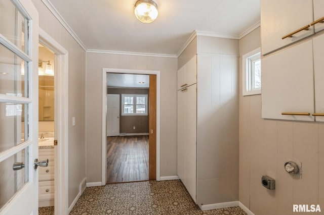 interior space featuring baseboards and crown molding