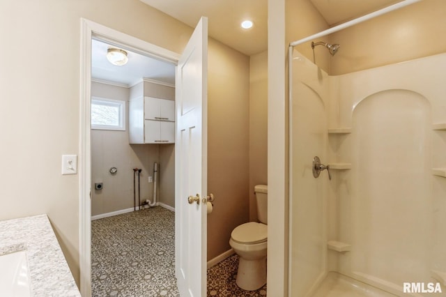 full bath featuring toilet, a stall shower, baseboards, and vanity