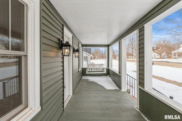 snow covered deck with covered porch