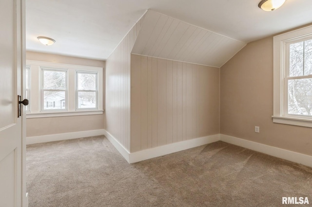 bonus room with light carpet, baseboards, and lofted ceiling