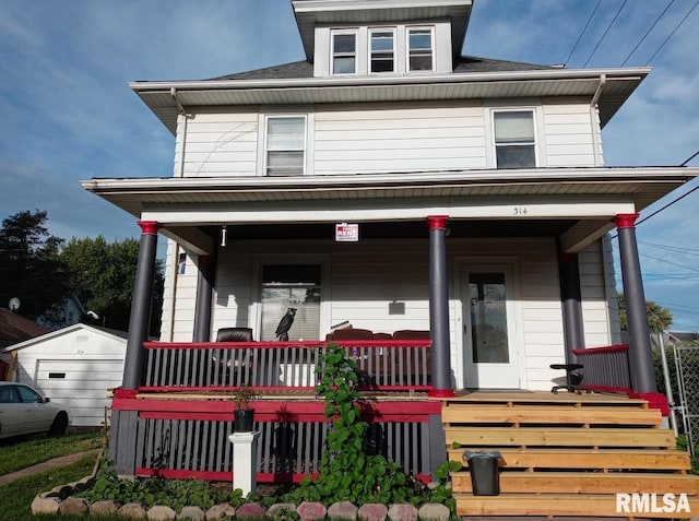 view of front of property with a porch, a garage, and an outdoor structure