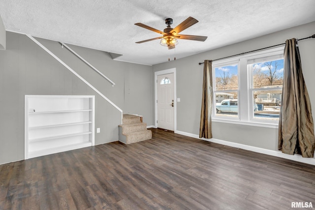 foyer with ceiling fan, dark hardwood / wood-style floors, and a textured ceiling