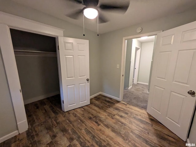 unfurnished bedroom featuring ceiling fan, a closet, and dark hardwood / wood-style floors