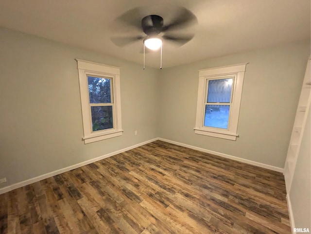 unfurnished room with ceiling fan and dark hardwood / wood-style floors