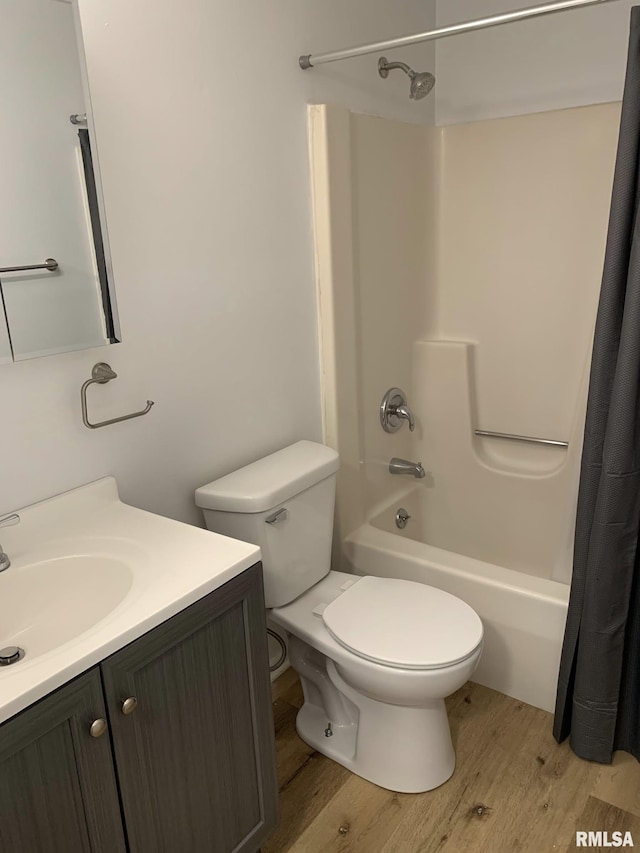 full bathroom featuring toilet, vanity, wood-type flooring, and shower / tub combo