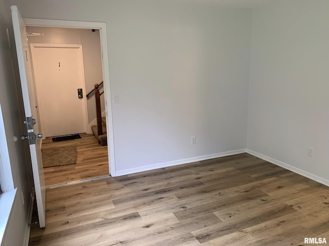 spare room featuring wood-type flooring