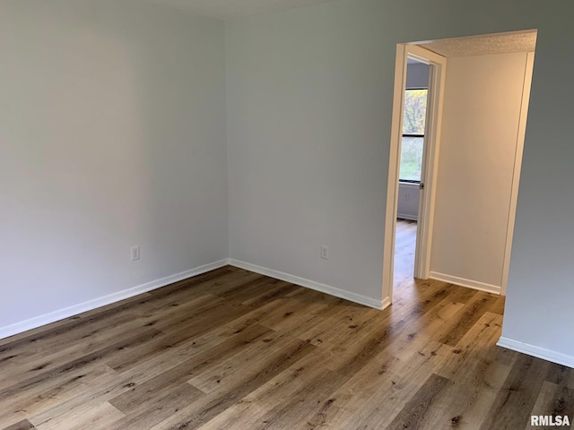 unfurnished room with hardwood / wood-style floors