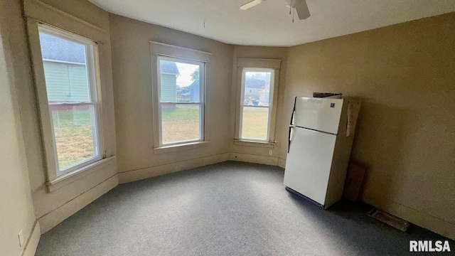 unfurnished dining area featuring ceiling fan