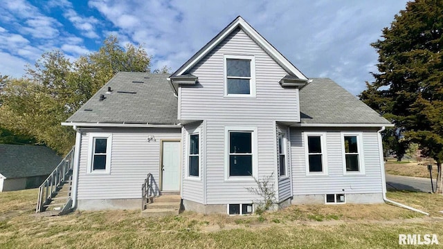 back of property featuring a lawn