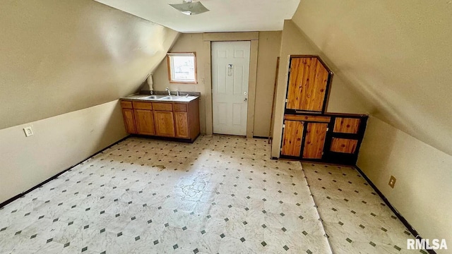 bonus room with lofted ceiling and sink