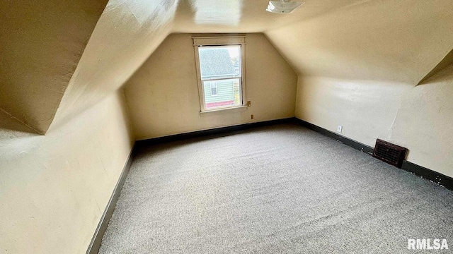 bonus room featuring lofted ceiling and carpet flooring