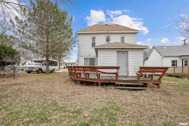 rear view of property with a wooden deck