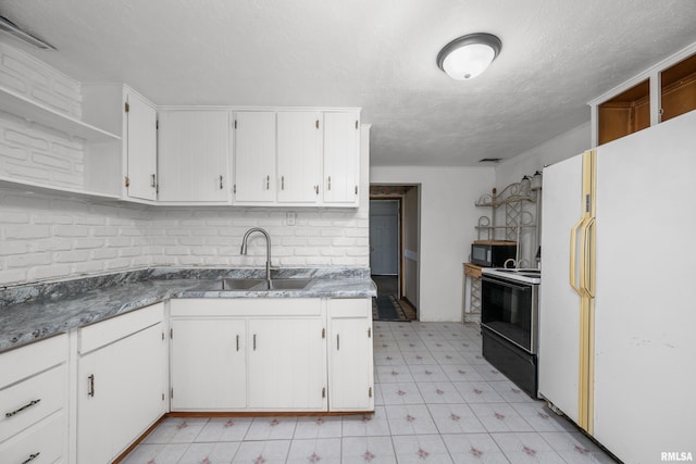 kitchen featuring black appliances, white cabinets, a textured ceiling, and sink