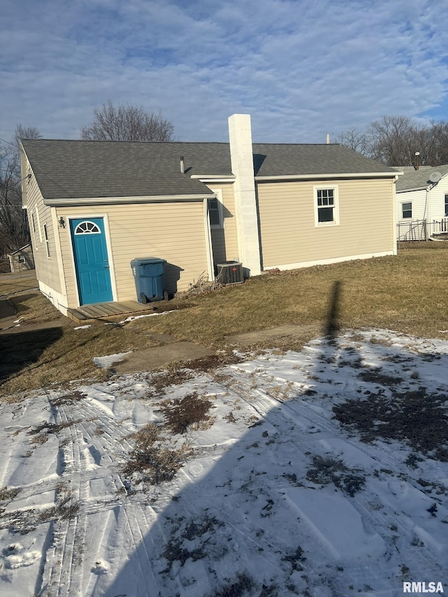 view of snowy exterior with central AC unit