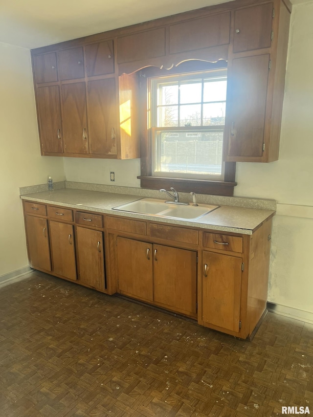 kitchen featuring sink and dark parquet flooring