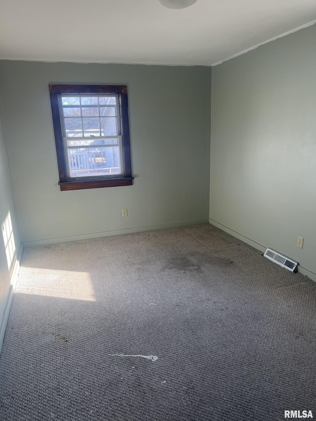 empty room with carpet floors and a wealth of natural light