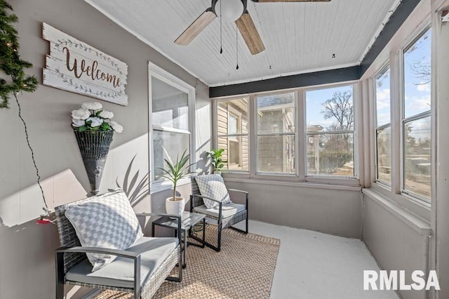 sunroom with ceiling fan and wood ceiling