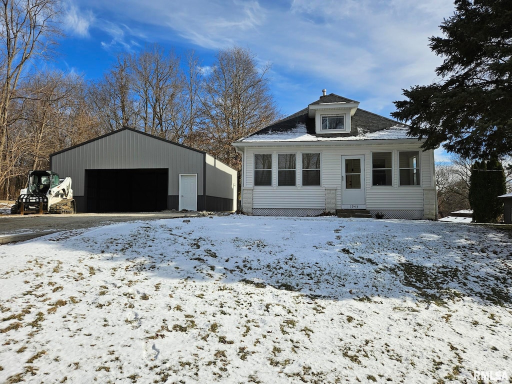 view of front of house with a garage and an outdoor structure