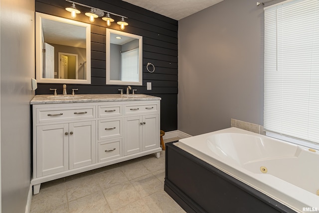 bathroom featuring vanity, tile patterned floors, a washtub, and wooden walls