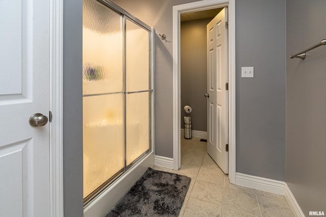 bathroom featuring tile patterned flooring and a shower with shower door