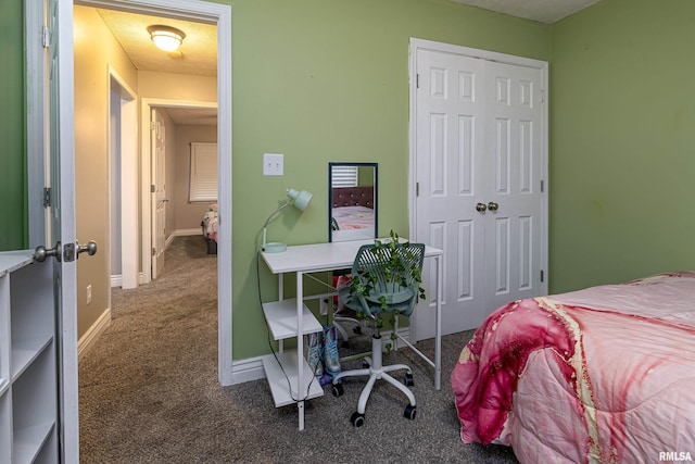 bedroom with a closet and dark colored carpet