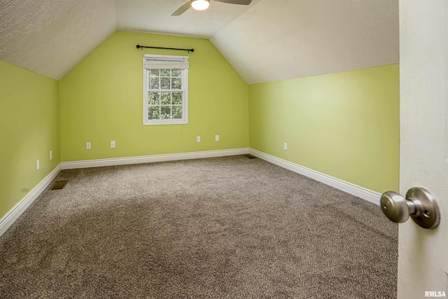 bonus room with ceiling fan, a textured ceiling, carpet, and vaulted ceiling