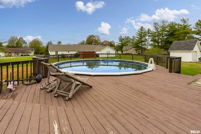 wooden terrace featuring a lawn