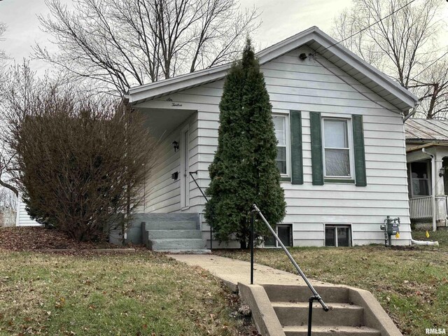 view of side of home featuring a yard