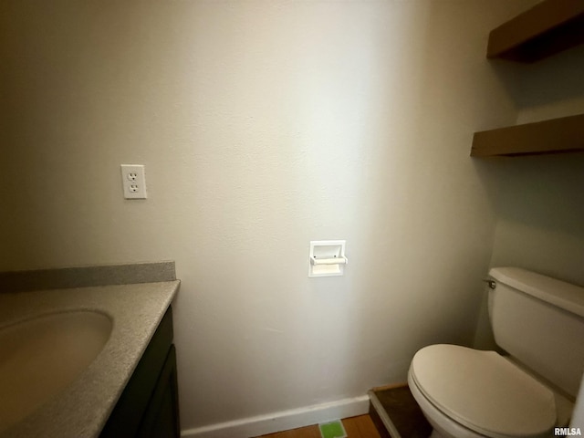 bathroom with toilet and vanity