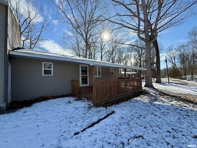 snow covered property featuring a deck