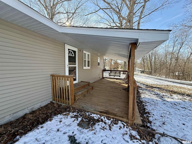 snow covered deck with covered porch