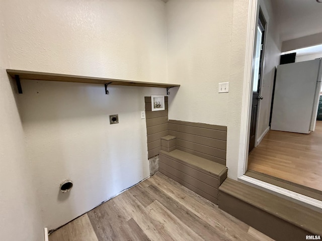 laundry room featuring washer hookup, hookup for an electric dryer, and light hardwood / wood-style floors