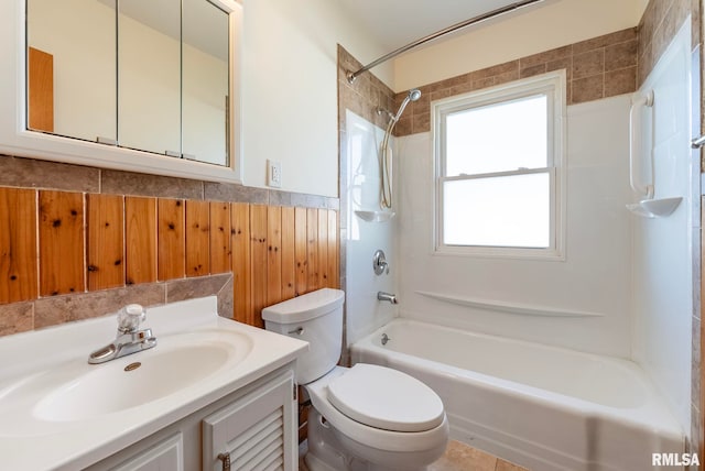 full bathroom with toilet, vanity, and tiled shower / bath