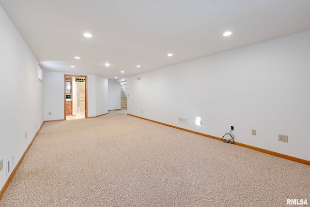 unfurnished room featuring light carpet