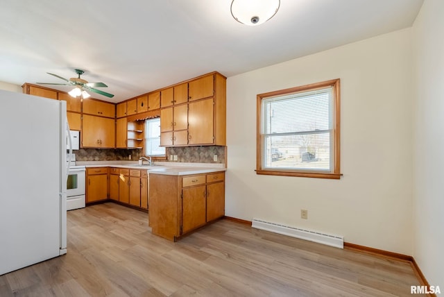 kitchen featuring tasteful backsplash, ceiling fan, sink, white appliances, and baseboard heating