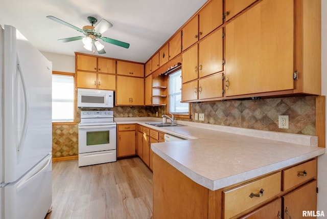 kitchen with tasteful backsplash, ceiling fan, sink, and white appliances