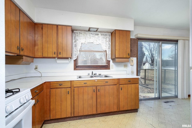 kitchen with sink and white gas stove