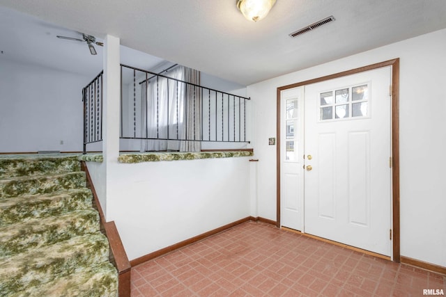 foyer entrance with a textured ceiling