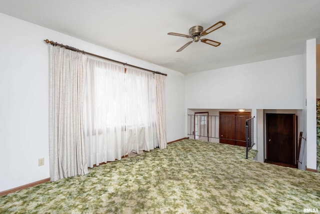 unfurnished living room featuring ceiling fan and carpet floors