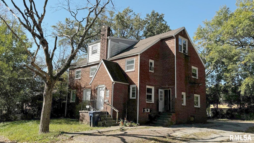 613 S 16th St, Mount Vernon, IL 62864 - view of front of house with a chimney and brick siding