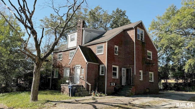 613 S 16th St, Mount Vernon, IL 62864 - view of front of house with a chimney and brick siding