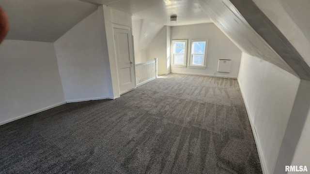 additional living space featuring vaulted ceiling and carpet