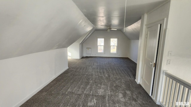 bonus room with lofted ceiling, ceiling fan, and dark colored carpet