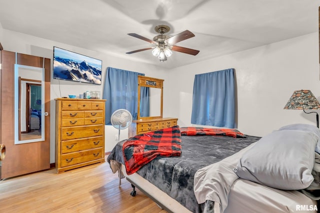 bedroom with ceiling fan and hardwood / wood-style flooring