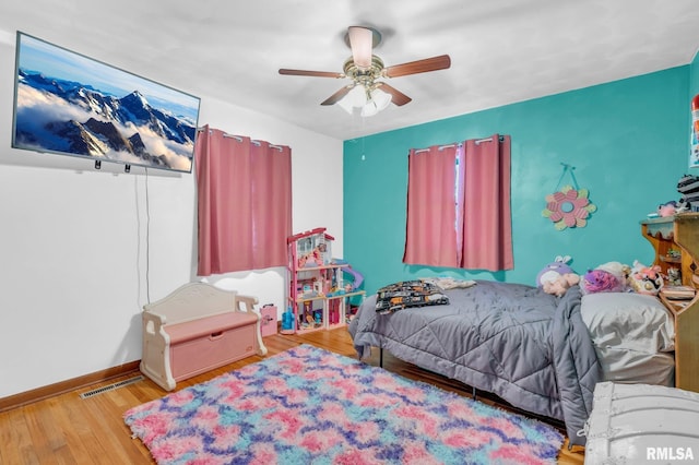 bedroom with ceiling fan and hardwood / wood-style flooring